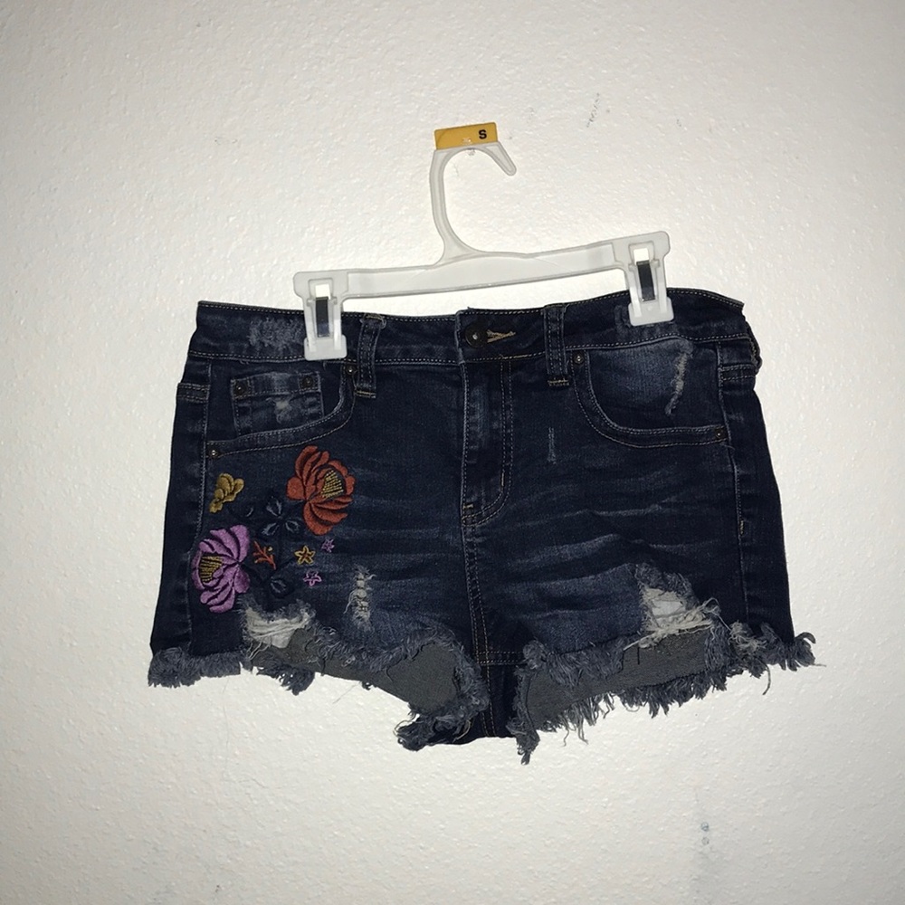 Cutoff jean shorts with hippie flower patches